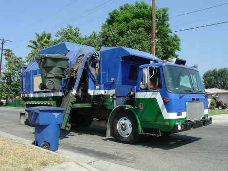 A reliable waste clearance service vehicle parked near a construction site